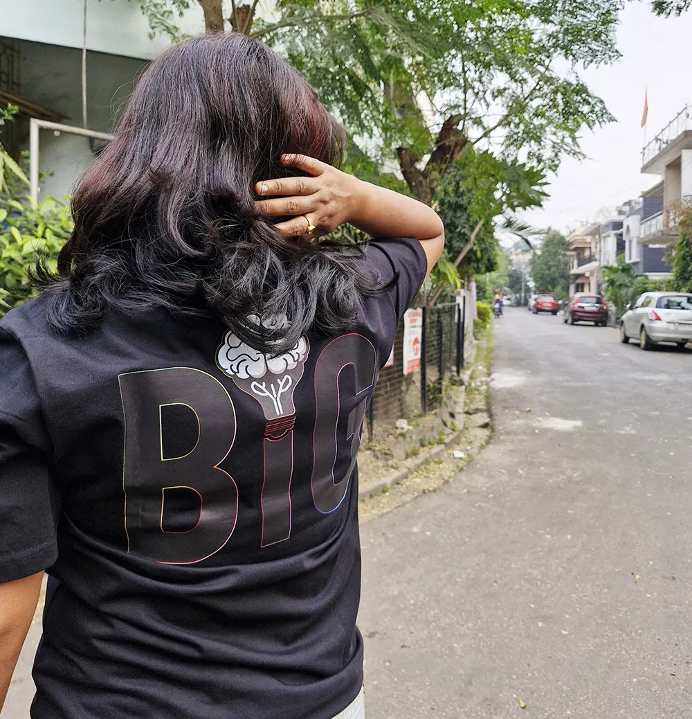 Woman wearing Think Big T-shirt back view