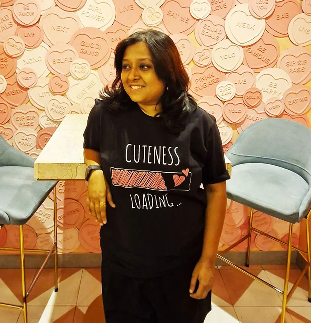 Woman standing in the cafe,wearing Black Cuteness Loading T-shirt