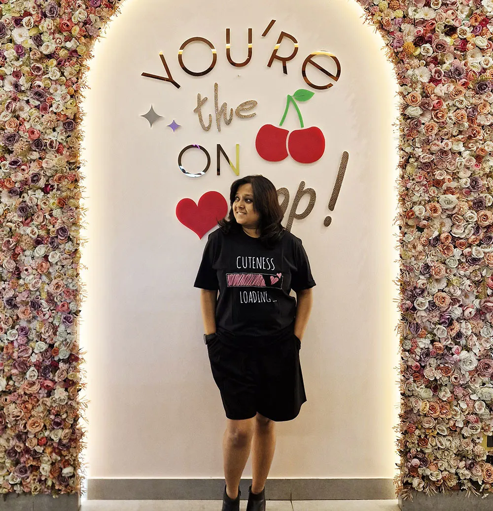 Girl wearing Cuteness Loading Black T-shirt, and giving a pose