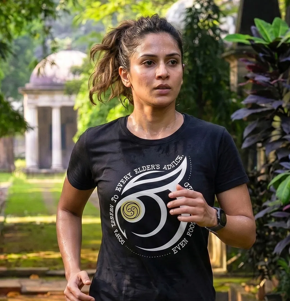 Woman wearing Black Even Fools Grow Old T-shirt and doing exercise