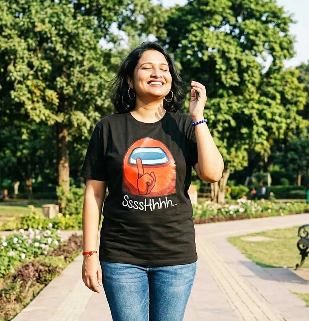 Woman wearing a funny Among Us T-shirt in the park